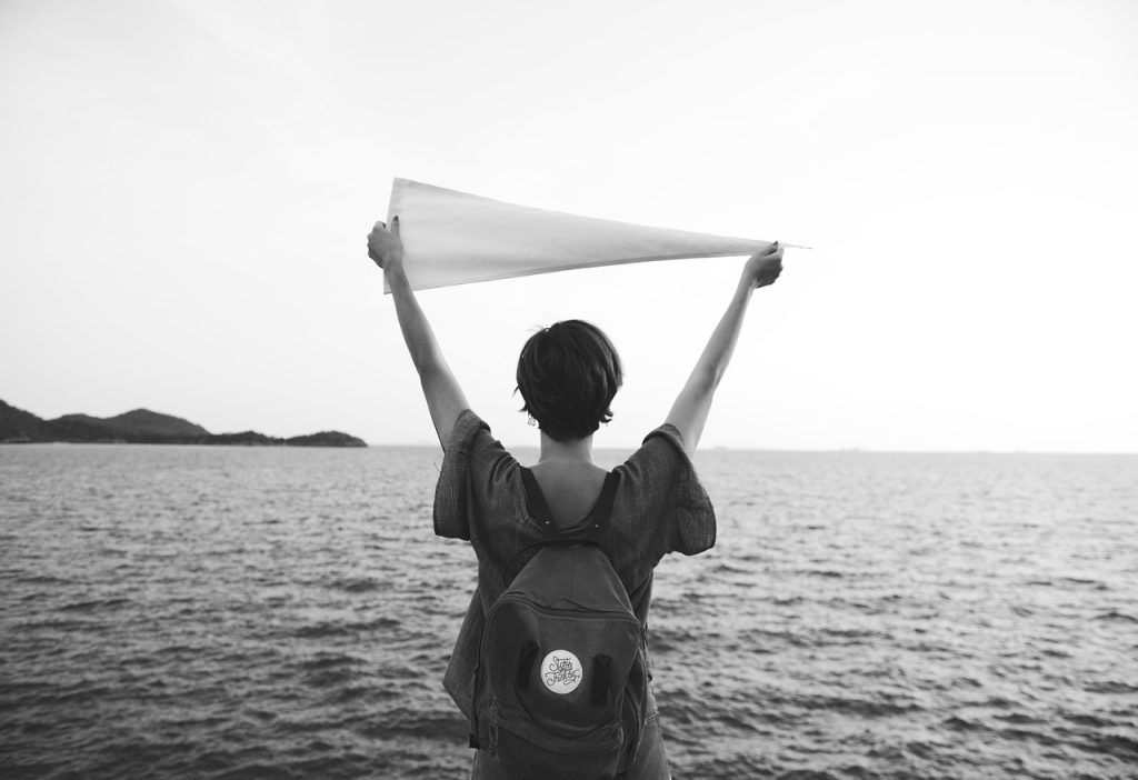 woman, flag, calm, freedom, location, travel, exploration, travel destination, serenity, wellness, casual, backpack, trip, place, expedition, traveler, journey, nature, sea, tourism, leisure, chill, relaxation, destination, holiday, resting, vacation, route, peace, summer, tour